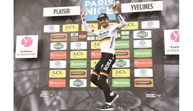 German rider Maximilian Schachmann celebrates on the podium after winning  the 154km 1st stage of the 78th Paris-Nice yesterday. (AFP)