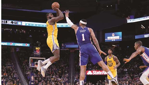 Golden State Warriors forward Eric Paschall (left) shoots the ball over Philadelphia 76ers forward Mike Scott (centre) in the fourth quarter at the Chase Center. PICTURE: USA TODAY Sports