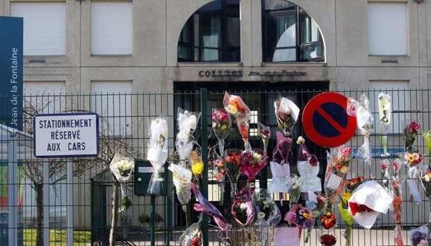 Sprays of flowers are seen on a fence of closed College Jean de la Fontaine after the death of a teacher from coronavirus in Crepy-en-Valois, France, March 7