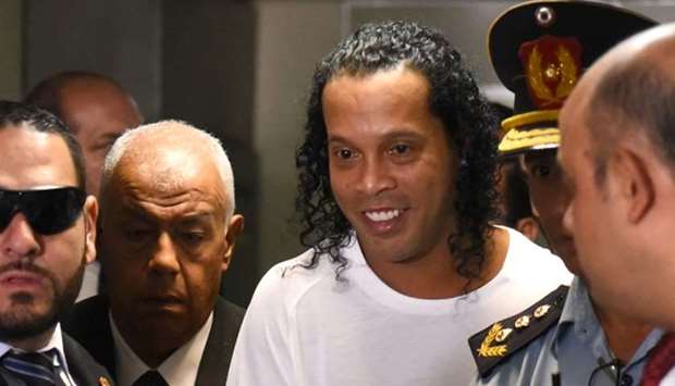 Brazilian retired football player Ronaldinho (C) arrives at Asuncion's Justice Palace