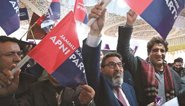 Former Peopleu2019s Democratic Party (PDP) leader Altaf Bukhari (second right) waves the new party flags during the launch event in Srinagar yesterday.