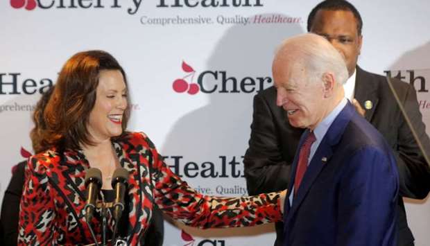 Democratic US presidential candidate and former Vice President Joe Biden speaks is welcomed by Michigan Governor Gretchen Whitmer during his campaign stop at Cherry Health clinic in Grand Rapids, Michigan,