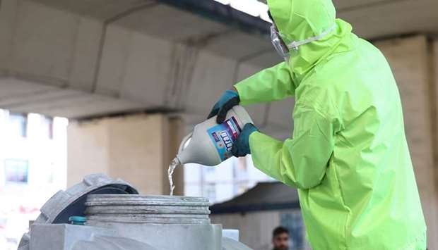 A member of the medical team wears a protective face mask, following the coronavirus outbreak, as he prepares disinfectant liquid to sanitise public places in Tehran, Iran. WANA/Nazanin Tabatabaee via REUTERS