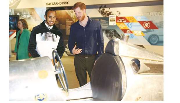 Britainu2019s Prince Harry, Duke of Sussex (C) speaks with Britainu2019s Formula One world champion driver Lewis Hamilton (L) during a visit to officially open the Silverstone Experience at Silverstone motor racing circuit, in central England on March 6. The Silverstone Experience is the new home to the archive of the British Racing Driversu2019 Club. The museum brings the extensive heritage of Silverstone and British motor racing to life through a dynamic, interactive and educational visitor experience.