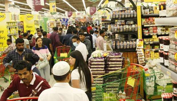 Residents shopping for necessities at a Doha store Monday