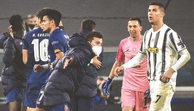 Juventusu2019 Cristiano Ronaldo (right) reacts as Portou2019s players celebrate at the end of the UEFA Champions League round of 16 second leg match in Turin. (AFP)
