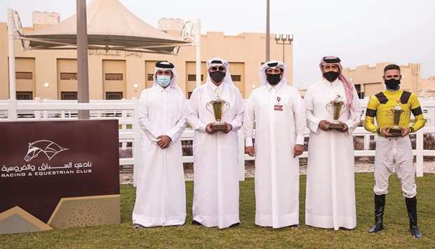 Sami Jassim al-Boenain (centre), Adviser to the Qatar Racing and Equestrian Club Chairman, with the winners of the Ain Khaled Cup after Zyzzyva won the six-furlong sprint at Al Uqda Equestrian Complex . PICTURES: Juhaim