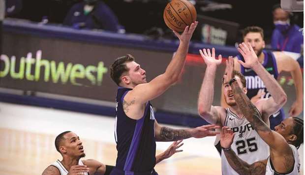 Dallas Mavericks guard Luka Doncic (second from left) shoots over San Antonio Spurs players during the second half of the NBA game at the American Airlines Centre in Dallas, Texas, United States, on Wednesday. (USA TODAY Sports)