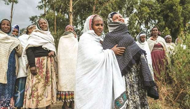 People mourn the victims of a massacre allegedly perpetrated by Eritrean soldiers in the village of Dengolat, north of Mekele, the capital of Tigray.