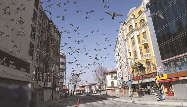 Birds fly past a solitary pedestrian in Ulus District of Ankara during a weekend curfew imposed by authorities in an attempt to halt the spread of the coronavirus pandemic (file). Turkeyu2019s gross domestic product expanded 5.9% from 2019, faster than all G20 nations except Chinau2019s 6.5%. The median of 20 forecasts in a Bloomberg survey was for 6.9% expansion.