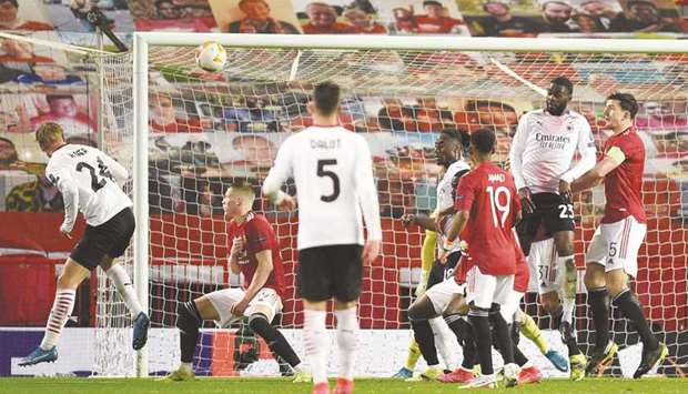 AC Milanu2019s Simon Kjaer (left) heads the ball to score against Manchester United during the UEFA Europa League round of 16 first leg match in Manchester. (AFP)