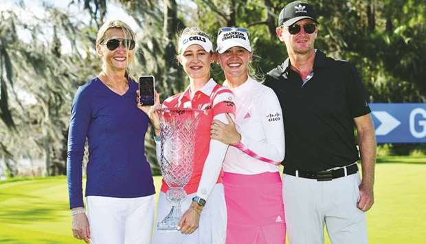 Nelly Korda of the United States poses with her family and the trophy after winning Gainbridge LPGA at Lake Nona Golf and Country Club in Orlando, Florida. (Getty Images/AFP)