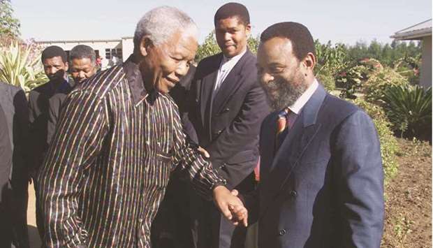 In this file photo taken on June 12, 1999, outgoing South African president Nelson Mandela is welcomed by Zulu King Goodwill Zwelithini (right) at his Dlamahlahla Palace in Mahhashini in Kwazulu-Natal province.