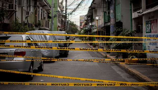 A view shows a makeshift barrier set up on a street of a village under lockdown amid rising coronavirus disease (Covid-19) infections, in Manila, Philippines