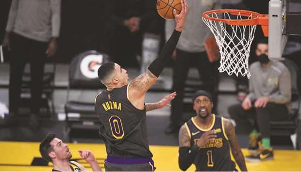 Los Angeles Lakers forward Kyle Kuzma (centre) goes up for a shot past Indiana Pacers guard TJ McConnell (left) during the second half of the NBA game at Staples Center in Los Angeles, United States, on Friday. (USA TODAY Sports)