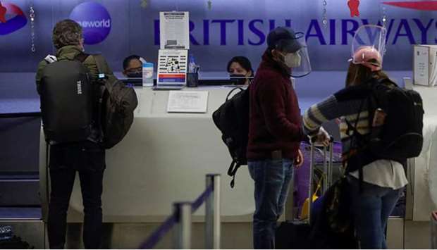 Passengers are seen at the counter of British Airways to check in for their flights to London at the Benito Juarez International Airport, in Mexico City, Mexico December 21, 2020.