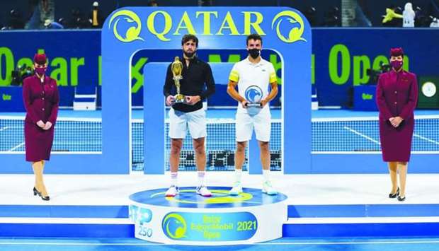 Georgia's Nikoloz Basilashvili (second from left) lifted the Qatar ExxonMobil Open Falcon trophy after beating Spain's Roberto Bautista Agut (second from right) in the final at Khalifa International Tennis and Squash Complex on Saturday.