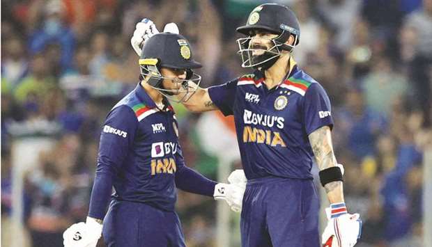 Indiau2019s Virat Kohli (right) congratulates teammate Ishan Kishan after the latter reached his half century during the second Twenty20 international match against England in Ahmedabad, India, yesterday. (Reuters)