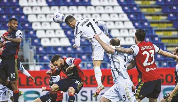 Juventusu2019 Portuguese forward Cristiano Ronaldo heads the ball to open the scoring during their Serie A match against Cagliari at the Sardegna Arena in Cagliari yesterday. (AFP)