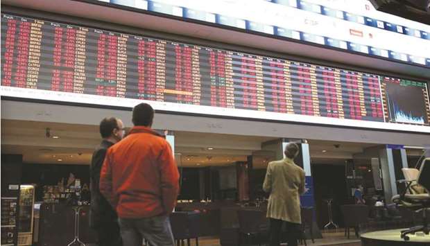 Visitors view the electronic board displaying stock prices at the Brasil Bolsa Bacao (B3) stock exchange in Sao Paulo. Brazil may deliver the Group of 20u2019s first rate hikes in 2021 this week, potentially lending support to two currencies caught in the crosshairs amid surging US Treasury yields.