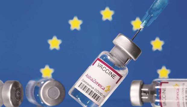 Vials labelled u201cAstra Zeneca Covid-19 Coronavirus Vaccineu201d and a syringe in front of a displayed EU flag. (Reuters)