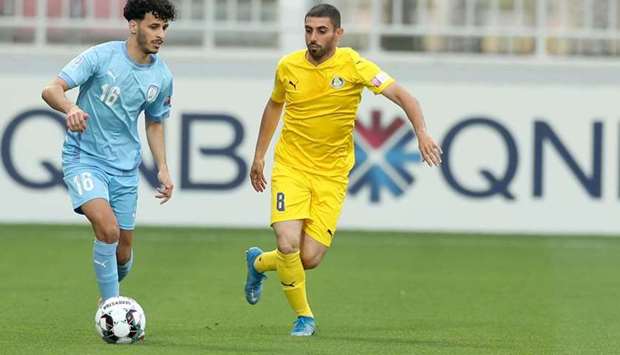 Al Wakrah's Khalid Muneer Mazeed (left) and Al Gharafa's Yousuf Muftah vie for the ball during the QNB Stars League match on Tuesday