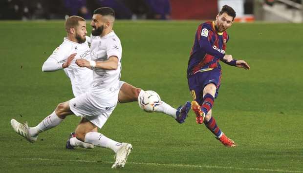 Barcelonau2019s Lionel Messi scores during the La Liga match against Huesca at the Camp Nou in Barcelona. (Reuters)
