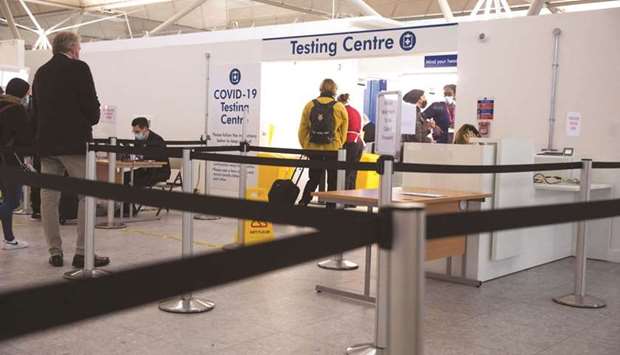 Passengers wait at the entrance to a Covid-19 testing centre at London Stansted Airport.