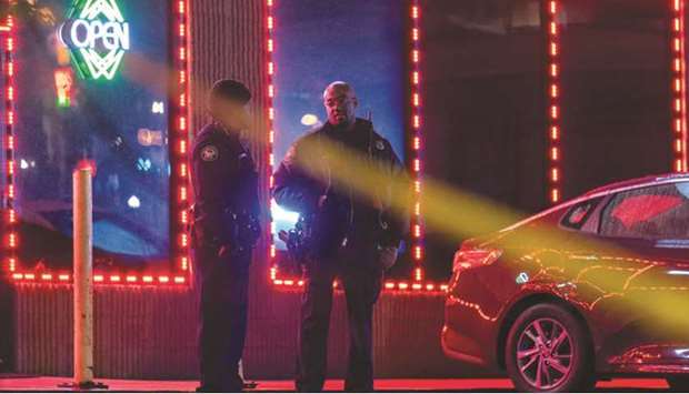 Law enforcement personnel outside a massage parlour where a person was shot and killed in Atlanta, Georgia. (AFP)