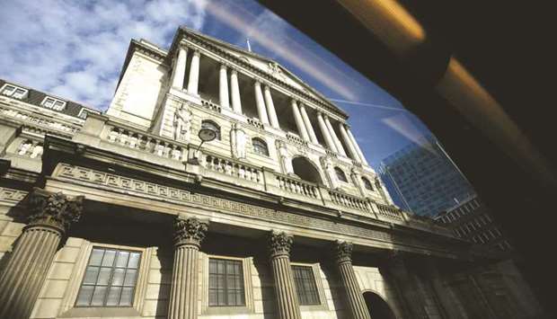The Bank of England is seen through the window of a bus as it travels along Threadneedle Street in London.