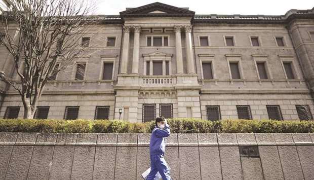 A pedestrian walks past the Bank of Japan headquarters in Tokyo. The BoJ unveiled a set of carefully crafted policy tweaks aimed at giving itself more flexibility to keep up its long quest to revive inflation.