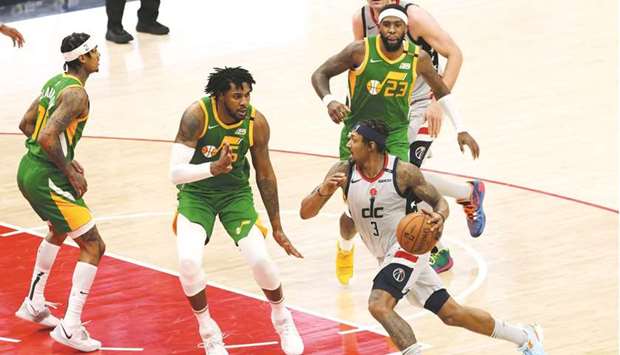 Washington Wizards guard Bradley Beal (right) drives to the basket as Utah Jazz forward Derrick Favors (centre) defends in the fourth quarter of the NBA game at Capital One Arena in Washington, DC, United States, on Thursday. (USA TODAY Sports)