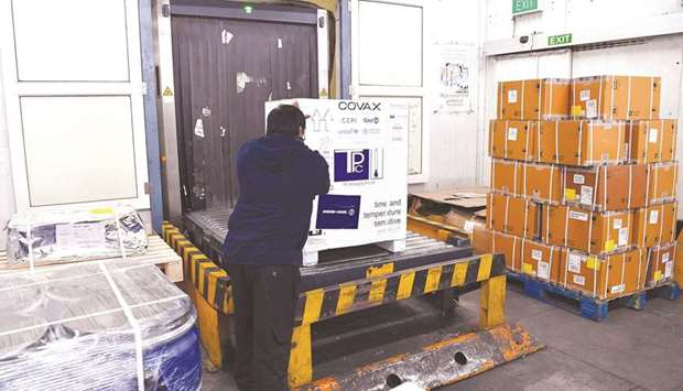 IMPRESSIVE: An airport staff unloads a carton box of Covishield vaccine developed by Pune based Serum Institute of India (SII) at the Mumbai airport as part of the Covax scheme, which aims to procure and distribute inoculations fairly among all nations. (AFP)