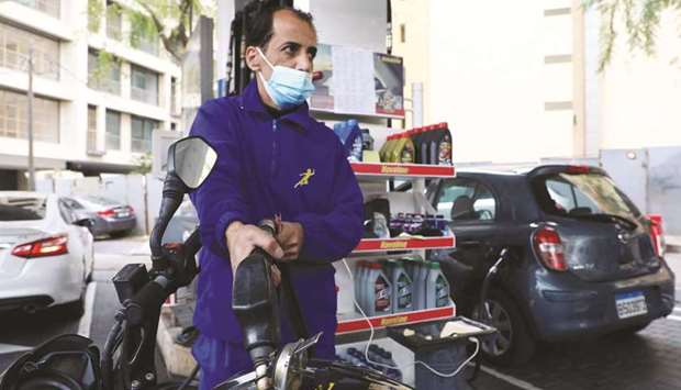 A worker fills up a motorbike at a petrol station in Beirut on March 18. The government plans to gradually increase prices at fuel stations in the coming months, reducing gasoline subsidies to 85% from 90%.