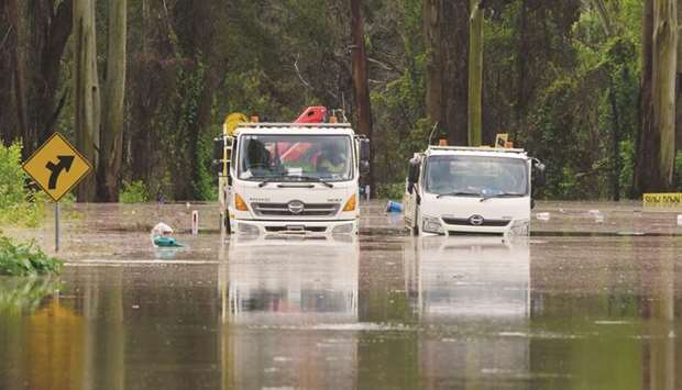 An image taken from video shows trucks stuck in a flooded road, following heavy rains in Taree, New South Wales, Australia.