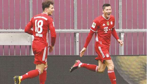 Bayern Munichu2019s Polish forward Robert Lewandowski (right) celebrates after scoring against VfB Stuttgart in Munich. (AFP)