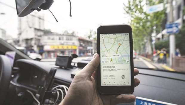 The Didi Chuxing ride-hailing app is displayed on a smartphone in an arranged photograph in Shanghai. Didi is accelerating plans for an initial public offering to as early as next quarter to capitalise on a post-pandemic turnaround, people familiar with its plans said.