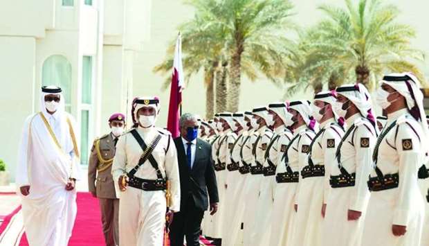His Highness the Amir Sheikh Tamim bin Hamad al-Thani accompanies Wavel Ramkalawan, the President of  Seychelles, as he inspects the Guard of Honour during the ceremonial reception