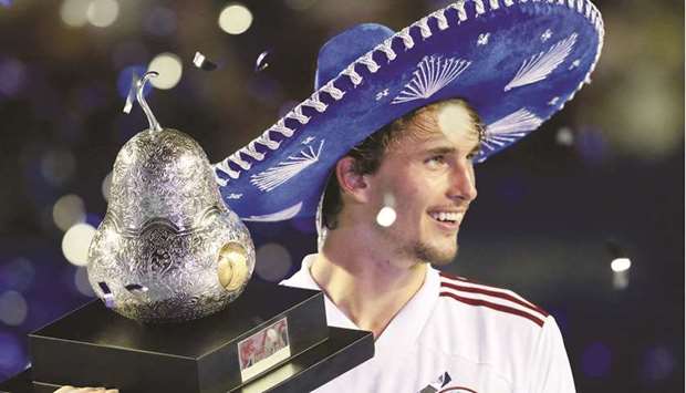 Germanyu2019s Alexander Zverev celebrates with the trophy after winning the Mexican Open on Saturday.
