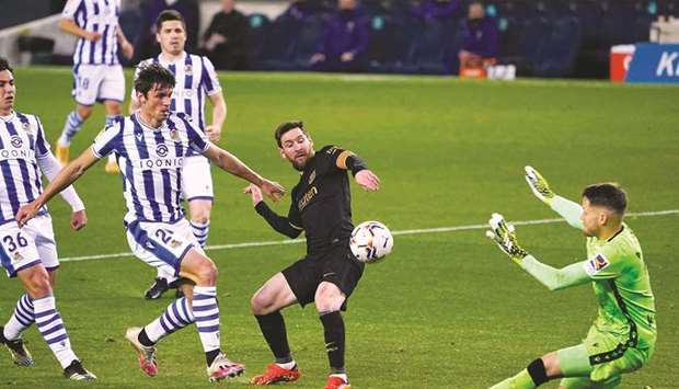 Barcelonau2019s Lionel Messi (second from right) scores their fourth goal during the La Liga match against Real Sociedad at Reale Arena in San Sebastian, Spain, on Sunday. (Reuters)