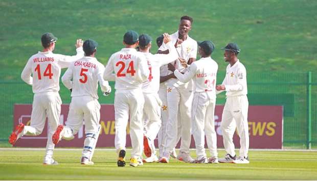Zimbabweu2019s Blessing Muzarabani (third right) celebrates with teammates after dismissing Afghanistanu2019s Abdul Malik in the first Test in Abu Dhabi. (Afghanistan Cricket Board)
