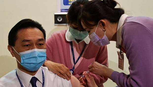 A medical worker receives a dose of the AstraZeneca vaccine against the coronavirus disease during a vaccination for medical workers in Taipei, Taiwan
