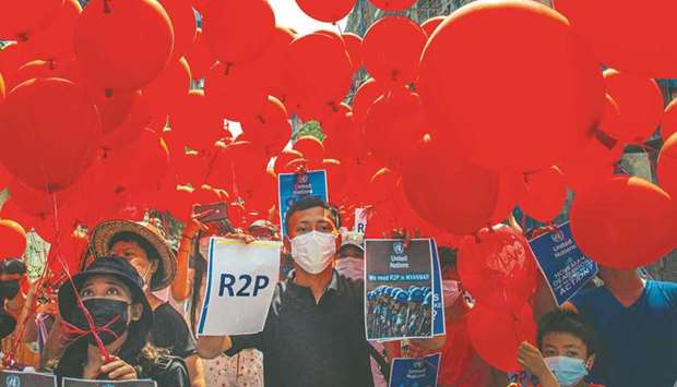 Residents preparing to set free balloons with messages relating to u201cR2Pu201d, or the u201cResponsibility to Protectu201d principle that the international community is justified in taking action against a state that is deemed to have failed to protect its population from atrocities, in Yangonu2019s Hlaing township, as security forces continue to crackdown on demonstrations by protesters against the military coup.