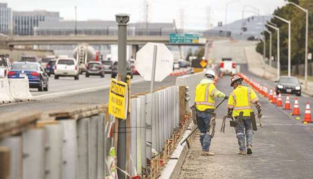 Contractors work on a road under repair along Highway 101 in San Mateo, California. President Joe Biden is betting that a multi-trillion economic plan centred around infrastructure spending will do more than bolster an American economy hammered by the coronavirus pandemic: It will ensure his countryu2019s competitiveness against China for decades to come.