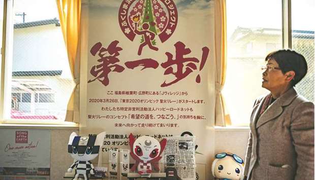 In this picture taken on February 28, 2021, Tokyo 2020 Olympic torch relay runner Yumiko Nishimoto poses for a photo at a community centre in Hirono, Fukushima Prefecture. Nishimoto, a torchbearer on the first day, has u201cmixed feelingsu201d over the behind-closed-doors departure ceremony, which features a simplified programme with a reduced number of performers.