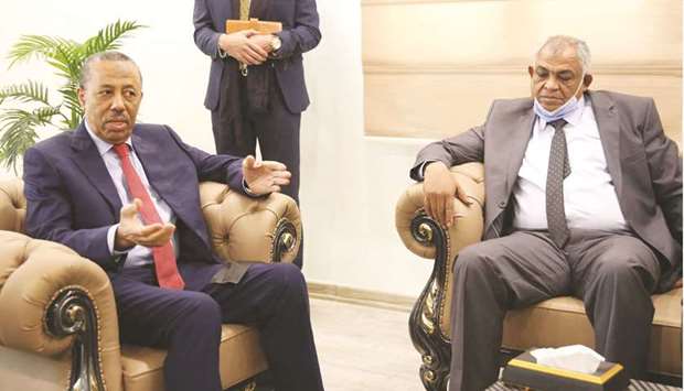 Libyau2019s Deputy Prime Minister in the national unity government, Hussein Attiya al-Gotrani (right), listens to Abdallah al-Thani (left), the former head of the parallel eastern government during a handover ceremony in the eastern Libyan city of Benghazi, yesterday.
