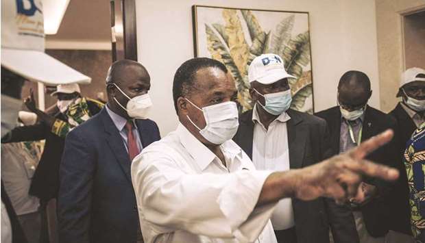 Re-elected Congou2019s President Denis Sassou Nguesso (centre) greets his entourage and campaign team at the headquarters of the Congolese Labor Party (PCT) in Brazzaville, yesterday.