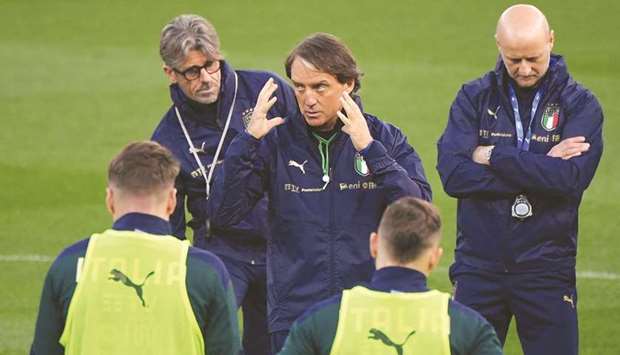 Italy coach Roberto Mancini (centre) talks to his players during a training session in Parma, Italy, yesterday. (Reuters)