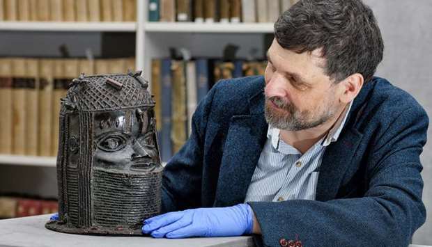 Neil Curtis, Head of Museums and Special collections is seen with one of the Benin bronze depicting the Oba of Benin at The Sir Duncan Rice Library in Aberdeen
