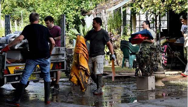 Residents clear out belongings from a home after floodwaters receded in Londonderry, a suburb outside Sydney 